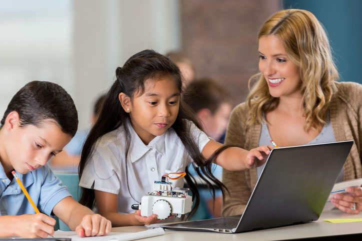 A smiley teacher motivating young students