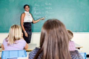 ESL Teacher lecturing in front of a chalkboard